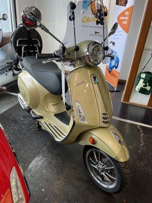 Vespa Primavera 150 75th Anniversary Edition with windshield and front turn signal upgrade kit.