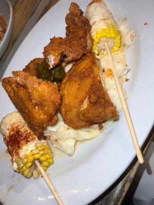 Fried chicken over mash potatoes with Mexican street corn