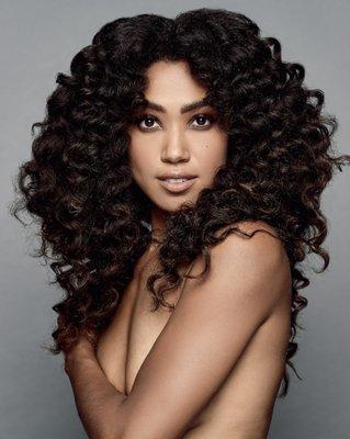 [Chelsea] Embrace your voluminous curls and natural hair with lots of layers and face-framing angles to create a sexy, edgy style.