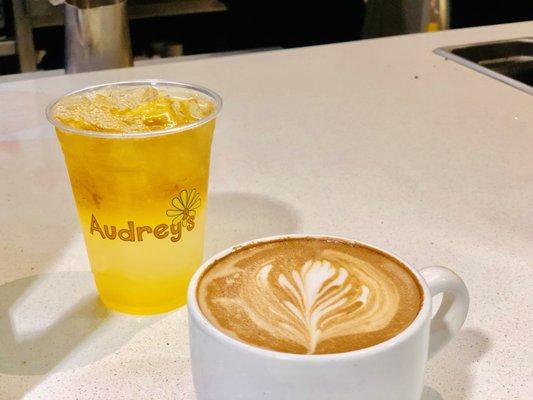 A black tea lemonade alongside a lovely latte with a gorgeous leaf drawn in milk foam. We serve nothing but the best here!