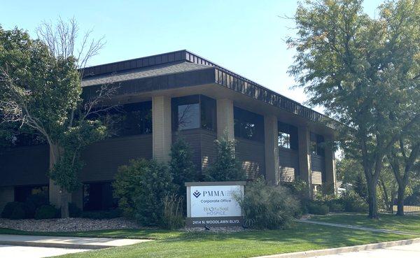 Exterior of PMMA headquarters building with sign in front