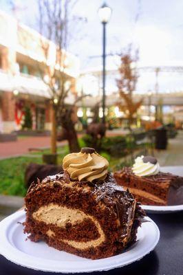 Coffee Swiss Roll Cake: chocolate cake, coffee cream, chocolate shavings, candied espresso beans & dusted with powdered sugar ($5.25).