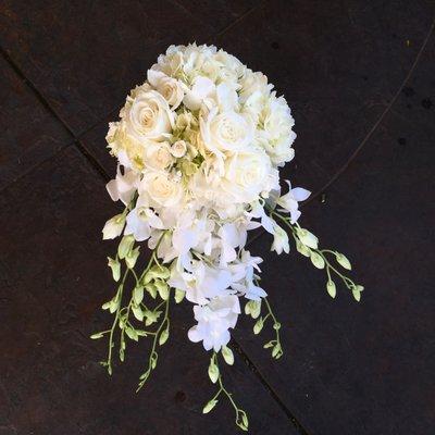 Cascading bouquet of orchids, hydrangea, and roses