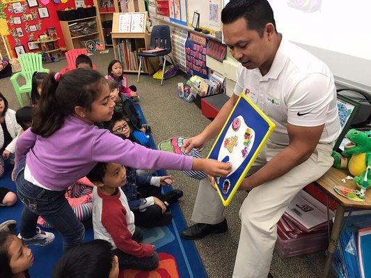 Dr. Dinh teaching children what is healthy for their teeth.