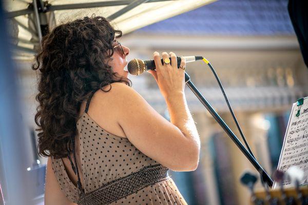 Voice, Flute, and Guitar instructor Ajda Snyder performs with ULS students and Staff at Somerville's Fluff Festival in Union Square.