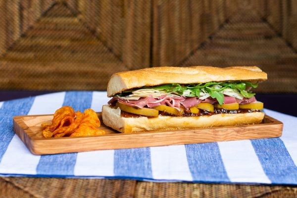 El Penzini: Prosciutto, Shaved Parmesan Cheese, Fig Paste, Arugula, Fresh Pears, and Balsamic Dressing on Baguette.