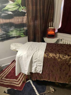 Treatment room with fireplace and lighted candles