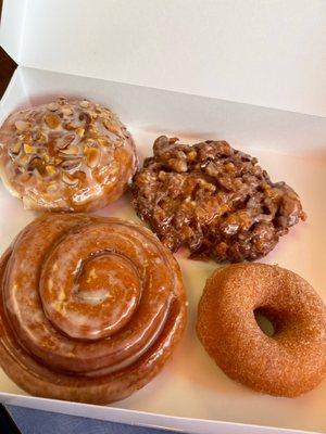 Donut filled with almond paste & topped with almond slivers, Apple fritter, cinnamon roll, & cinnamon sugar donut