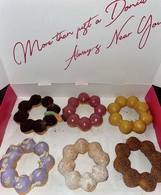 Half dozen mochi donuts: (l to r) Mud Pie, Black Currant, Mango, Taro Crunch, Sugar Snow, & Dirty Churro