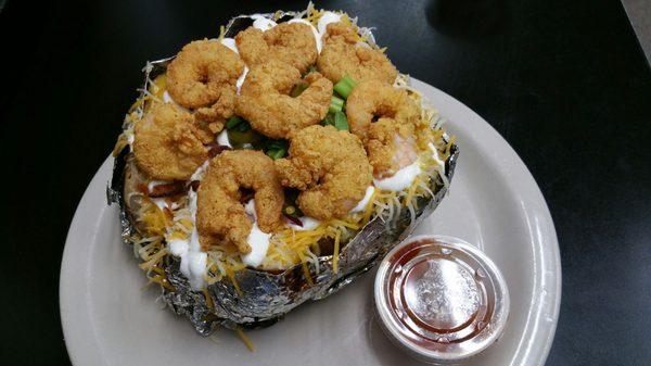 Stuffed Baked Potato with fried shrimp and a side of BBQ sauce