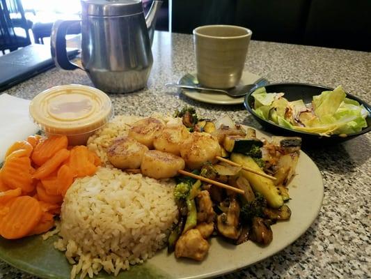 Teriyaki chicken with mixed vegetables and scallops. Steamed carrots and a lot of fried rice.