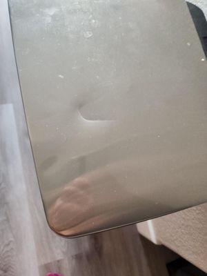 Dented garbage can