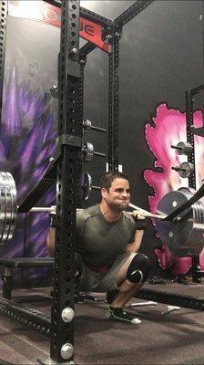 One of the barbell racks in use.