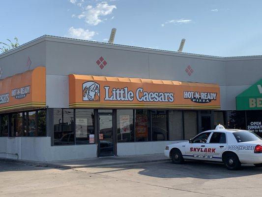 Front of Little Caesars in strip mall.