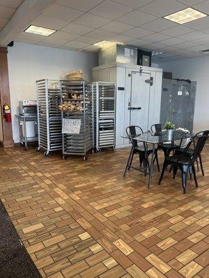 A couple tables for dine in and fresh baguettes