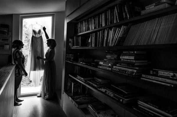 A bride gets dressed at her midcoast Maine wedding. Photo by Kate Crabtree Photography.