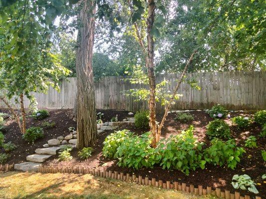 Stone steps leading up into a beautiful garden scape