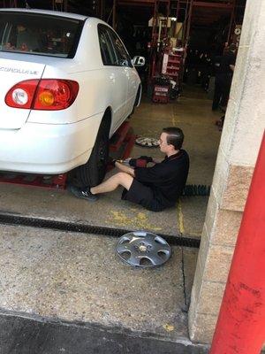 Tires being rotated by Zach, a DTC employee