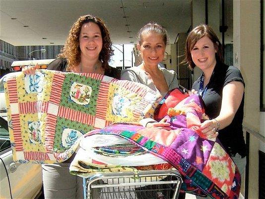 Volunteers working on the recycled quilt