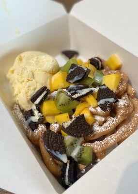 Funnel Cake with Ice Cream topped with Mango, Kiwi, and Oreos.