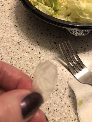 Finger of medical glove in husbands salad