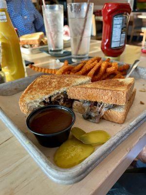 Chopped brisket sandwich with extra sauce and sweet potato fries.  Delicious!!