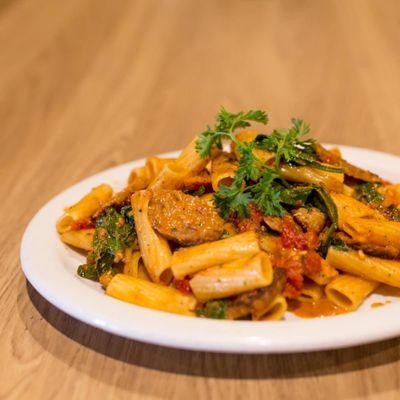 Yummy rigatoni with our hot italian sausage we can it in house and our sundried tomatoe pesto sauce