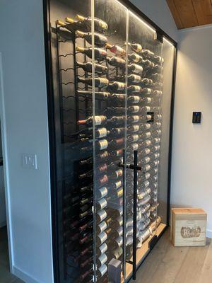 Porcelain slab at the back, side and ceiling with vents for cooling the wine storage