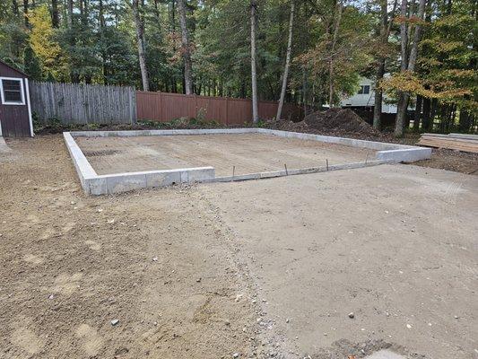 Backfilled with recycled concrete. Compacted hard as a rock and easy to work with.