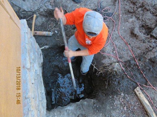 Mucking a pier location hole. No wonder this house was sinking.