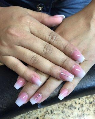 Fake nails with powdered pink and white ombré with 3 diamonds.