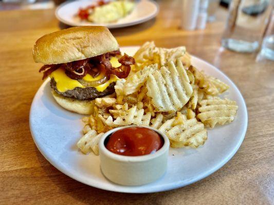 AAA Aged Beef Burger - served with caramelized onion, bacon, American cheese, trinity sauce, pickled green tomato, and a side of fries