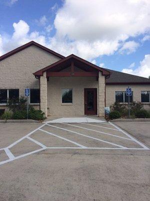 This is the outside of the building. Due to the trees and shrubs, it is a little difficult to see from FM 518.