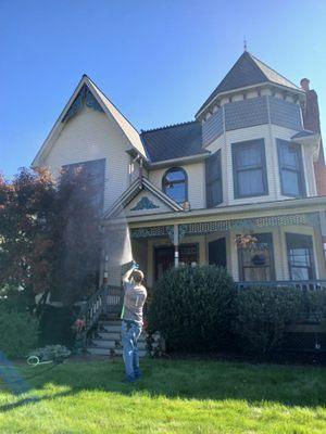 One of our team members washing the front side of the home