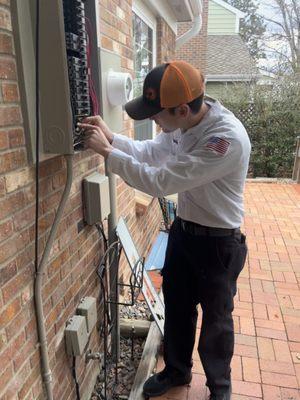 Tristan servicing an electric panel.