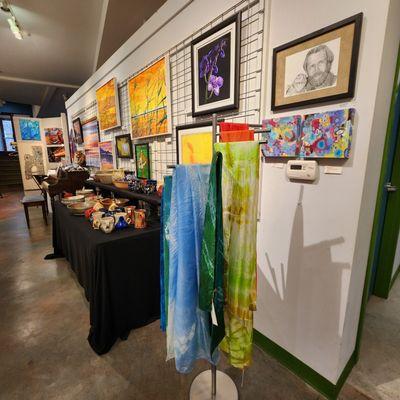 paintings, pottery and fiber art displayed in the gallery