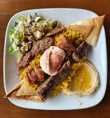 Mixed Kabob plate, with rice as a base, hummus and Greek salad. There were several other options.