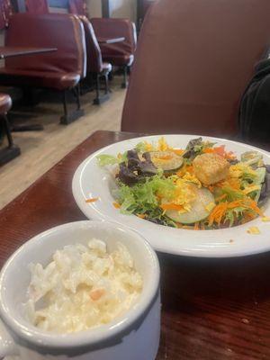 Cole slaw in a mug and garden salad.