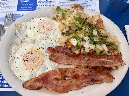 Two eggs over easy with bacon & homefries well done with peppers & onions