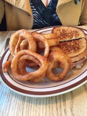 Reuben with a side of onion rings.