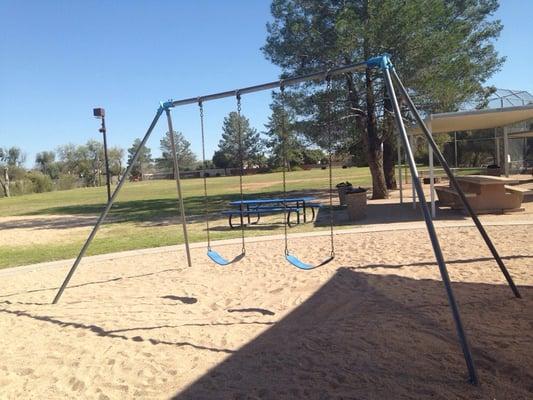 Two big kid swings, softball field in background