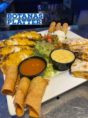 Tex Mex platter including hand made taquitos, quesadillas, and nachos.