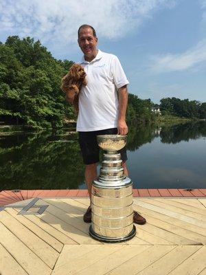 Owner Mike McGowan of MaidPro Pittsburgh with Mascot Heidi stand beside the Stanley Cup won by the 2015-16 Pittsburgh Penguins.