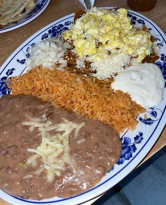 Chilaquiles Rojos with Eggs, Beans, Rice, and sour cream