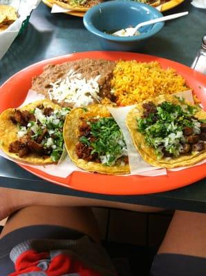 Three tacos. Pol, chorizo, and carne Asada with rice & beans