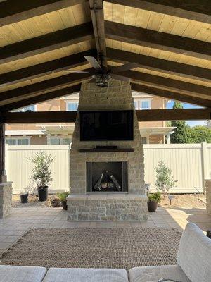 outdoor fireplace with stone veneer.