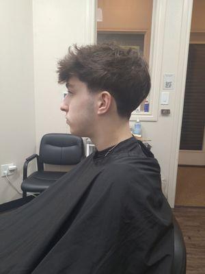 Teenage messy style haircut and low fade.