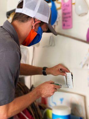 Replacing an outlet in the garage with a new, GFCI protected outlet. Check out our new masks to ensure our technicians/customers stay safe