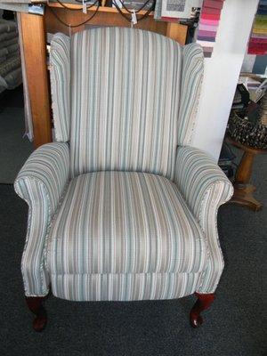 Recliner covered with a vertical stripe.