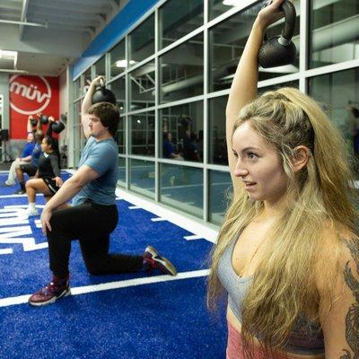 MUV Fitness Troutdale members using kettlebells in a group class